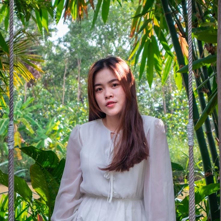 Avery Chen, Lead Design Curator at Distributed Logic Structure, reviewing corporate floral arrangements